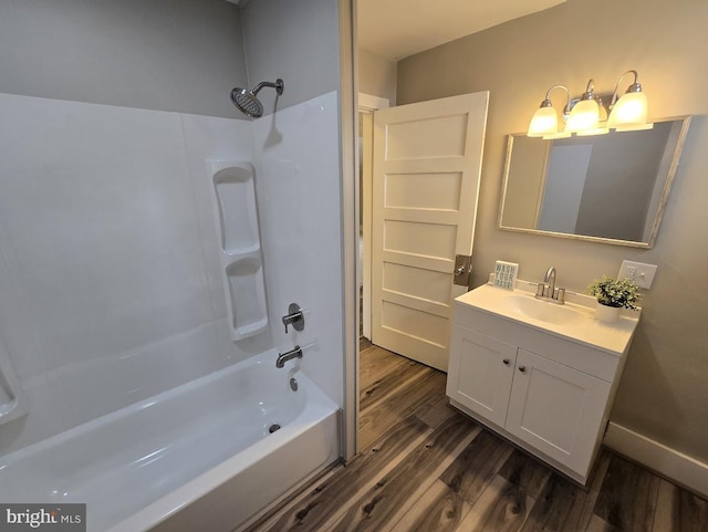 bathroom with hardwood / wood-style floors, vanity, and bathtub / shower combination