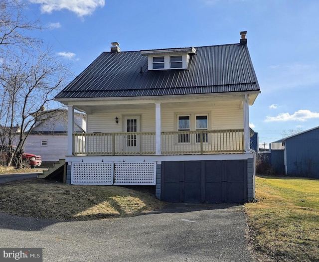 back of property featuring a lawn and a porch