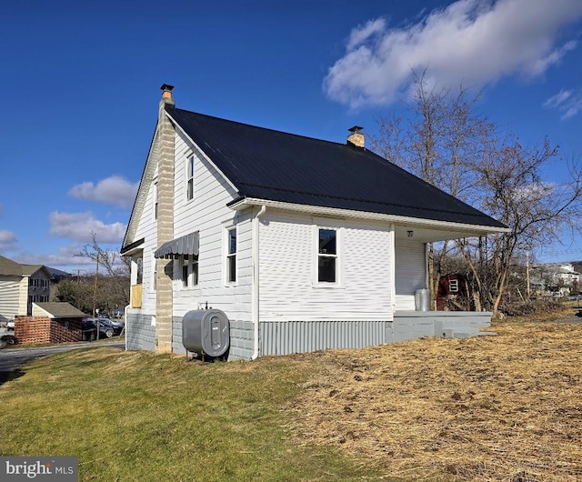 view of side of property with a lawn