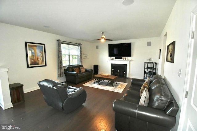 living room with ceiling fan and dark hardwood / wood-style flooring