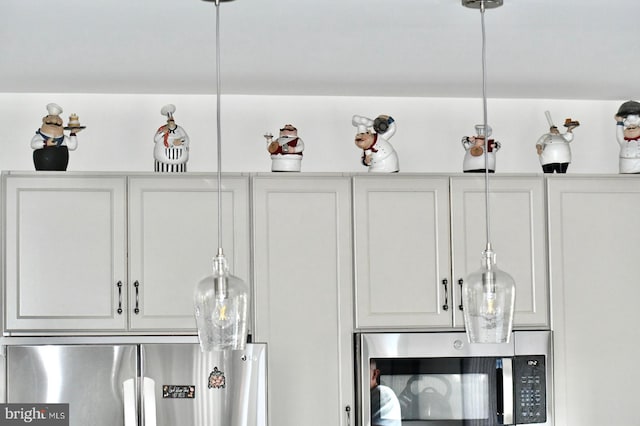 interior details featuring white cabinets and appliances with stainless steel finishes