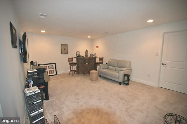 living room with carpet flooring and indoor bar