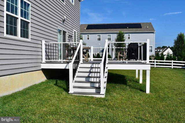 back of house with a gazebo, solar panels, a yard, and a wooden deck