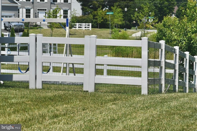 view of gate featuring a yard