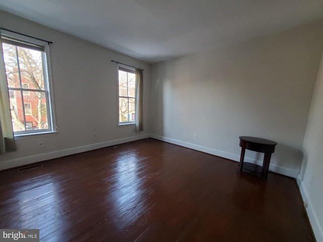 spare room featuring dark hardwood / wood-style floors