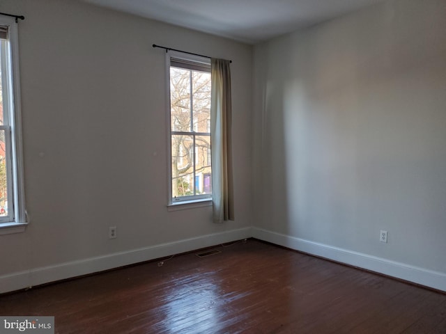 empty room featuring dark hardwood / wood-style flooring