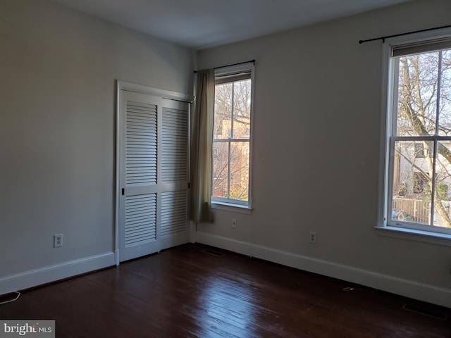 empty room featuring dark hardwood / wood-style flooring