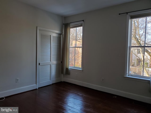 spare room with dark hardwood / wood-style flooring