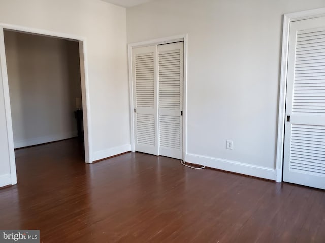 unfurnished bedroom featuring dark hardwood / wood-style floors