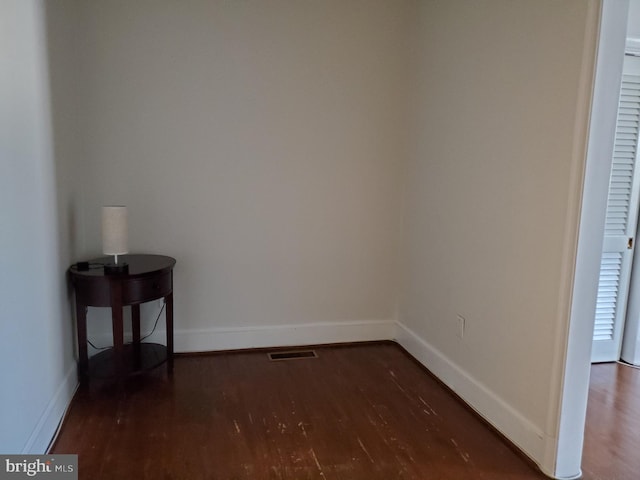 unfurnished room with dark hardwood / wood-style floors