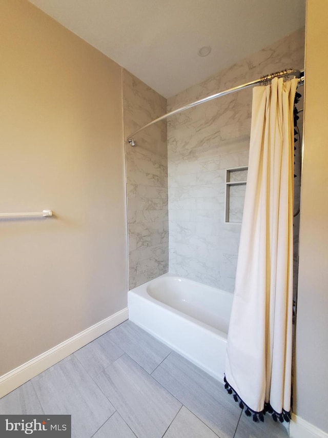 bathroom with shower / bath combo with shower curtain