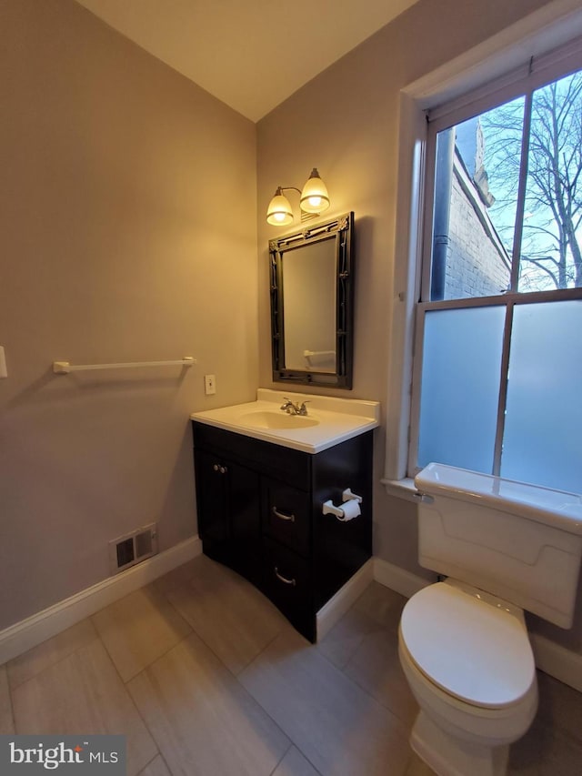 bathroom with tile patterned floors, vanity, and toilet