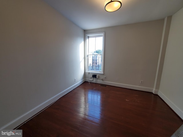 empty room featuring dark hardwood / wood-style floors