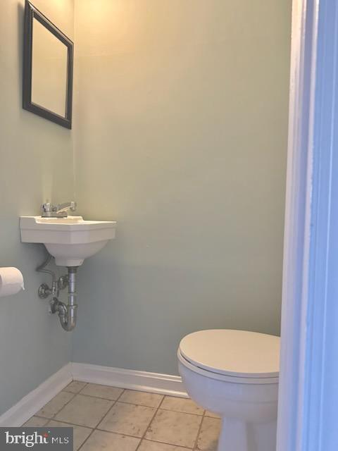 bathroom featuring tile patterned floors and toilet