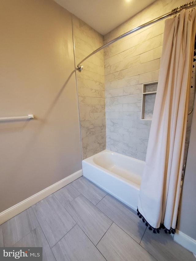 bathroom with shower / tub combo with curtain