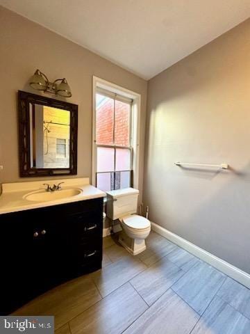 bathroom featuring vanity and toilet