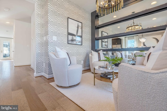 sitting room featuring hardwood / wood-style flooring and an inviting chandelier