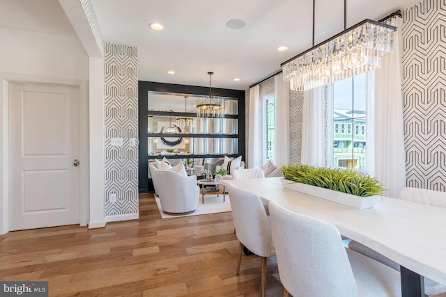 dining room with hardwood / wood-style floors and a notable chandelier