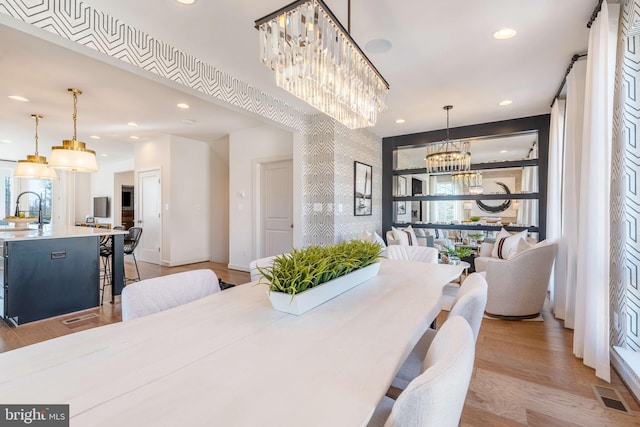 dining area featuring light hardwood / wood-style floors and sink