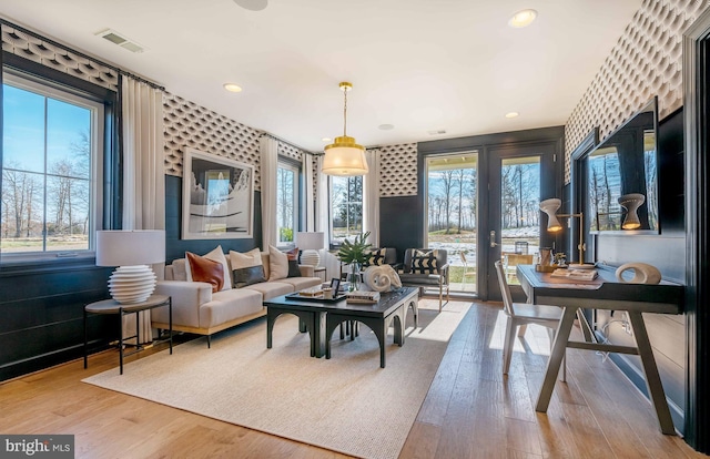 living room with a wealth of natural light and wood-type flooring