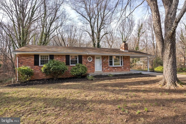 single story home with a front yard and a carport