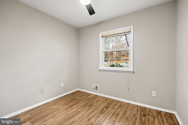 empty room featuring ceiling fan and light hardwood / wood-style flooring