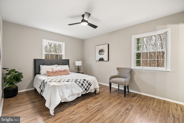 bedroom with hardwood / wood-style flooring and ceiling fan