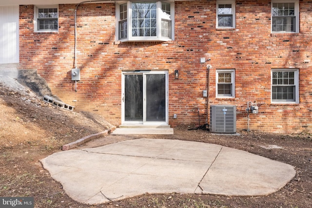 back of property featuring cooling unit and a patio area