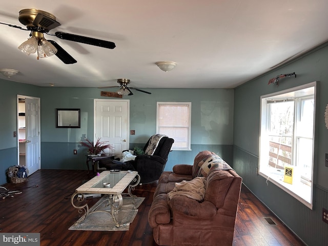 living room featuring dark hardwood / wood-style floors and ceiling fan