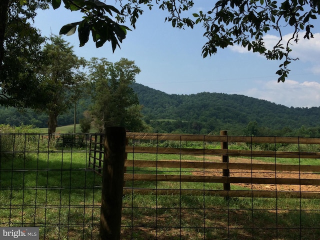 view of gate with a mountain view and a rural view