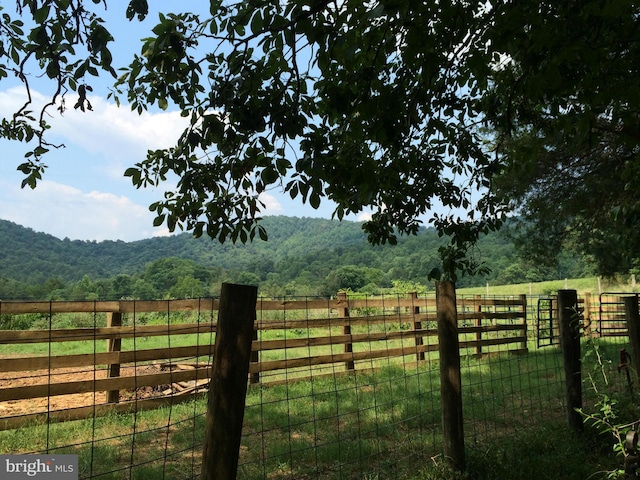 view of gate with a rural view