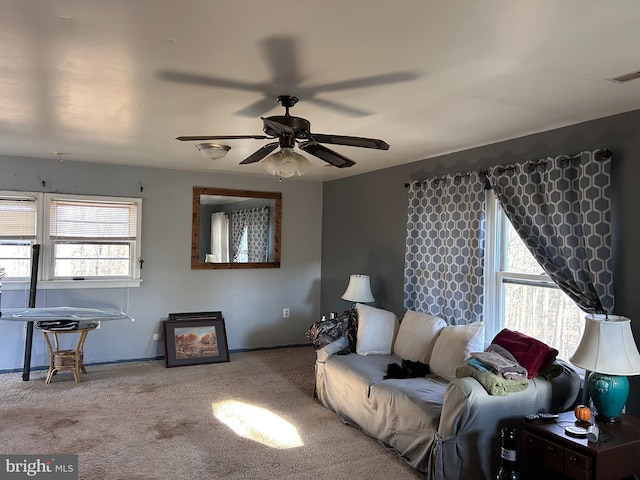 living room with ceiling fan and carpet