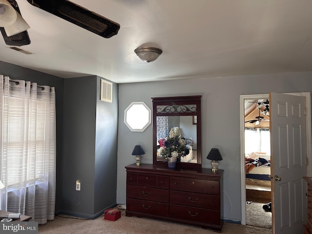 carpeted bedroom featuring multiple windows