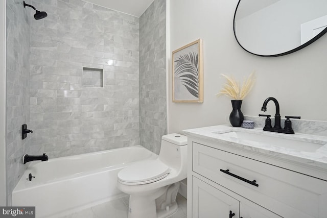 full bathroom featuring vanity, toilet, and tiled shower / bath