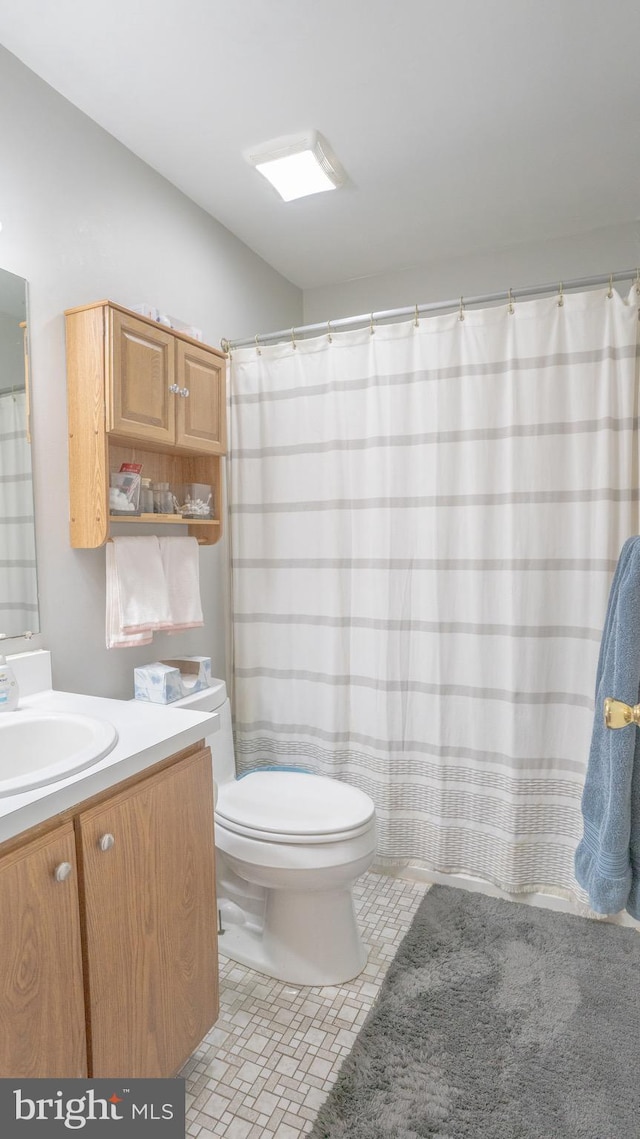 bathroom featuring vanity and toilet