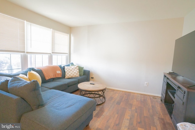 living room with dark hardwood / wood-style flooring and plenty of natural light