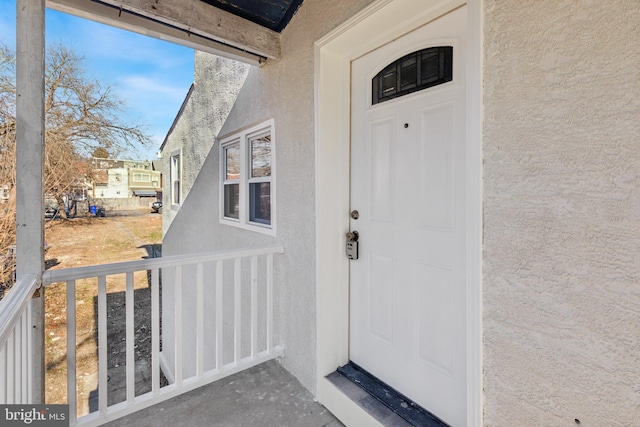 entrance to property featuring covered porch