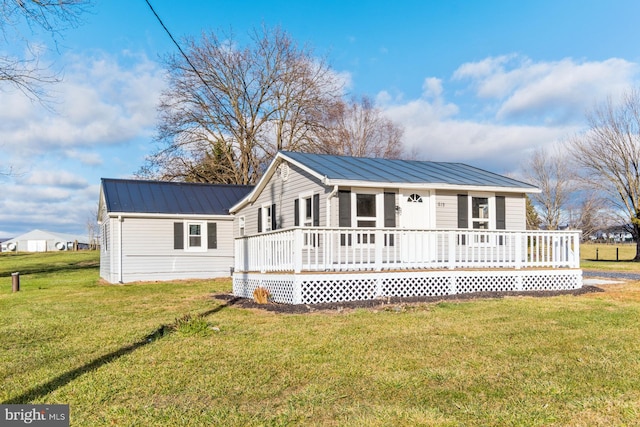 back of house featuring a lawn and a porch