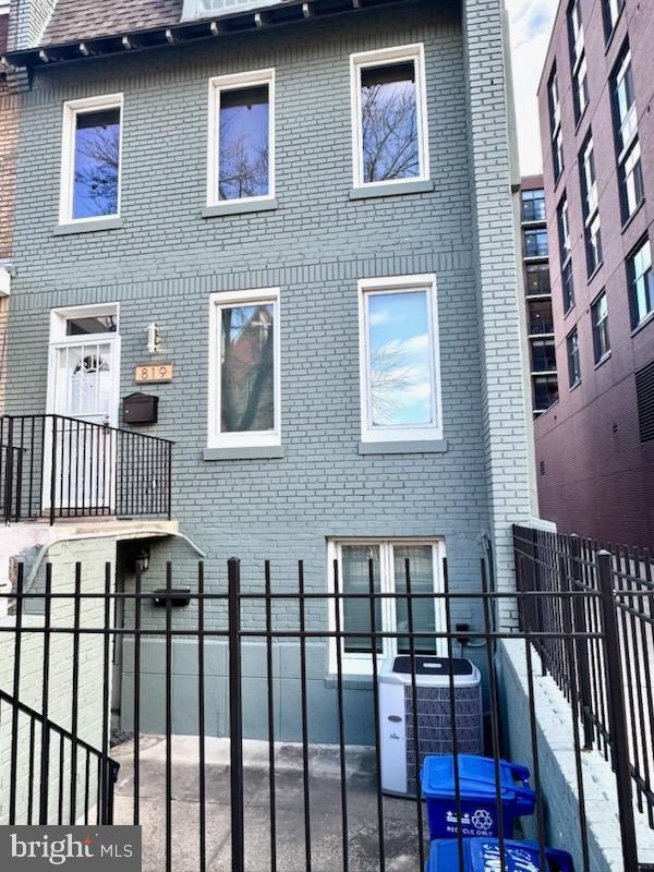 rear view of house with central AC unit