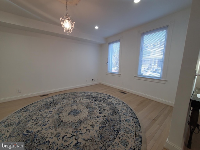 interior space with an inviting chandelier and light hardwood / wood-style floors