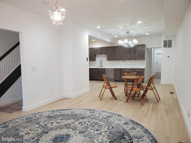 kitchen featuring dishwasher, light hardwood / wood-style floors, a notable chandelier, dark brown cabinetry, and tasteful backsplash