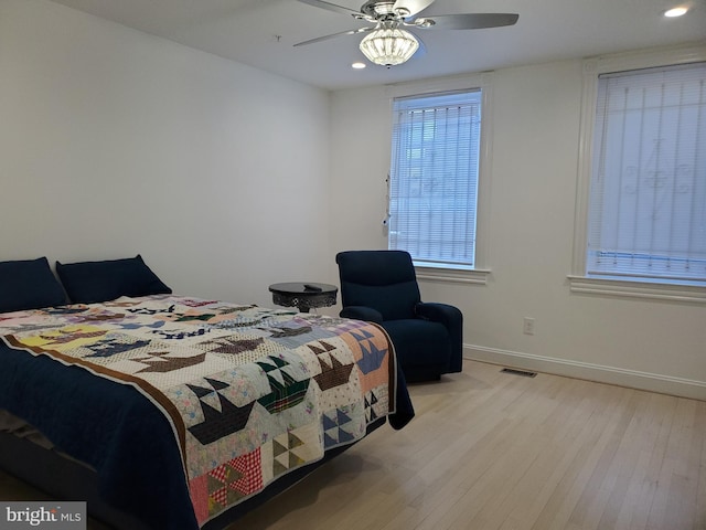 bedroom with ceiling fan and light wood-type flooring