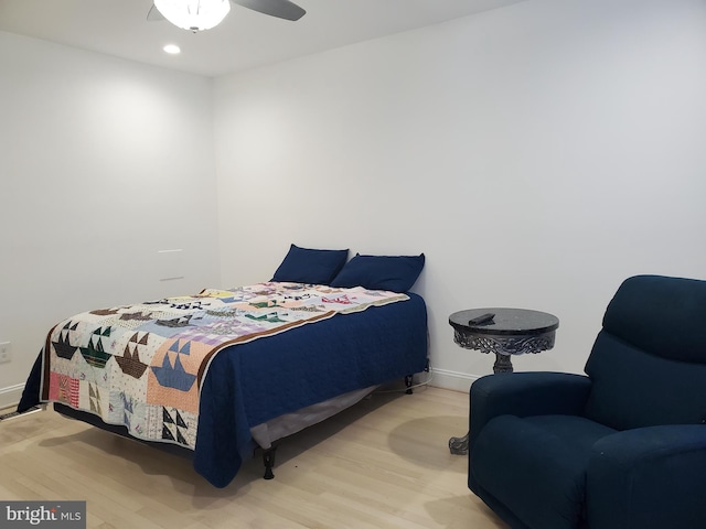 bedroom with ceiling fan and light hardwood / wood-style flooring