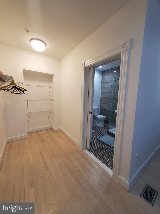 walk in closet featuring light hardwood / wood-style floors