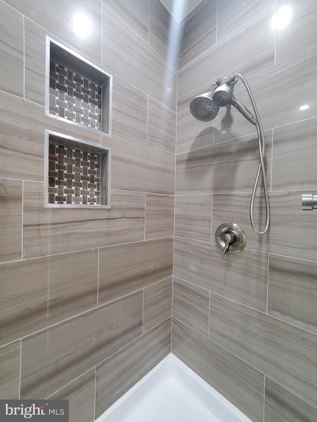 bathroom with tiled shower