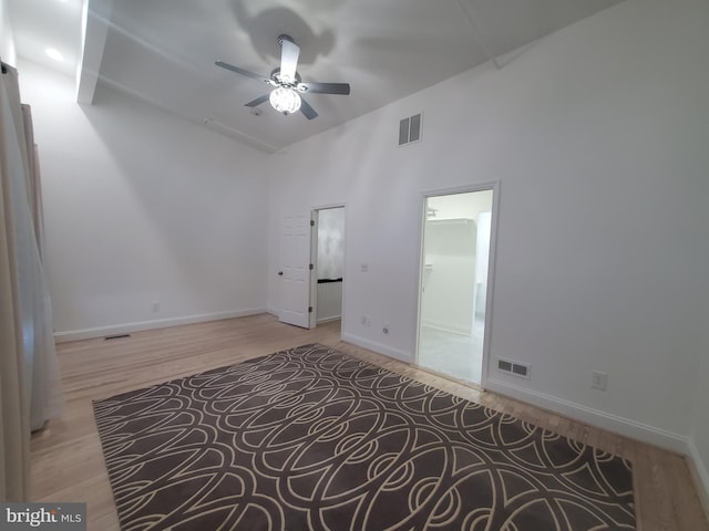 spare room featuring ceiling fan, light hardwood / wood-style flooring, and high vaulted ceiling