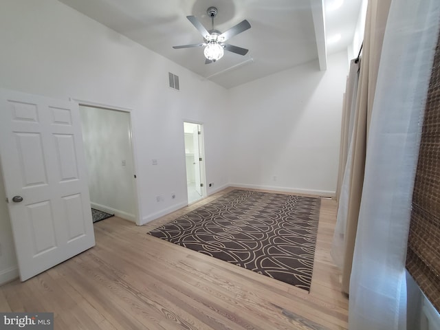 spare room with vaulted ceiling, ceiling fan, and light hardwood / wood-style floors