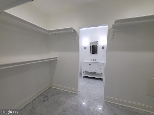 spacious closet featuring sink