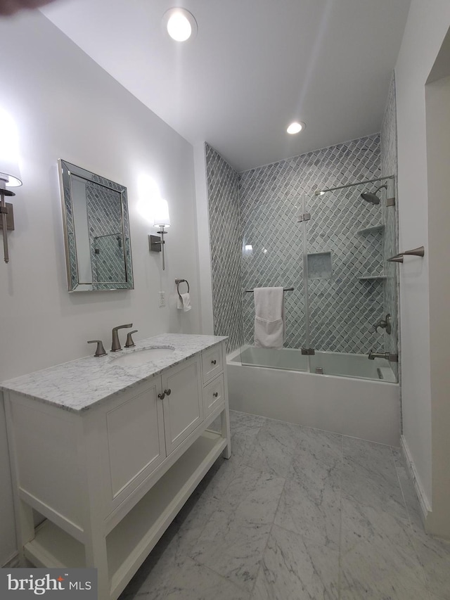 bathroom featuring vanity and tiled shower / bath