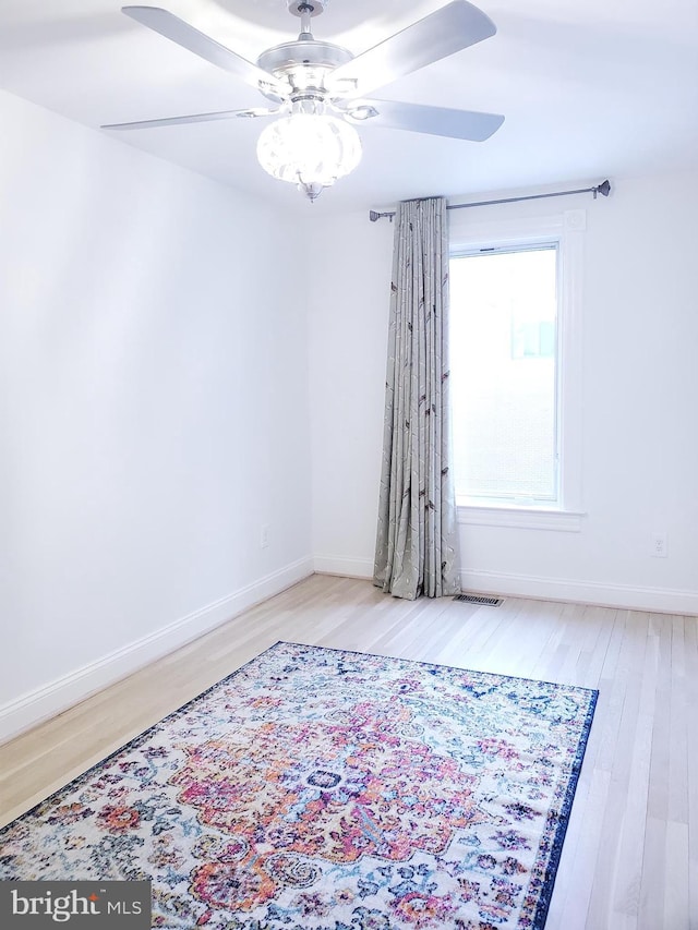 spare room featuring ceiling fan and light hardwood / wood-style flooring